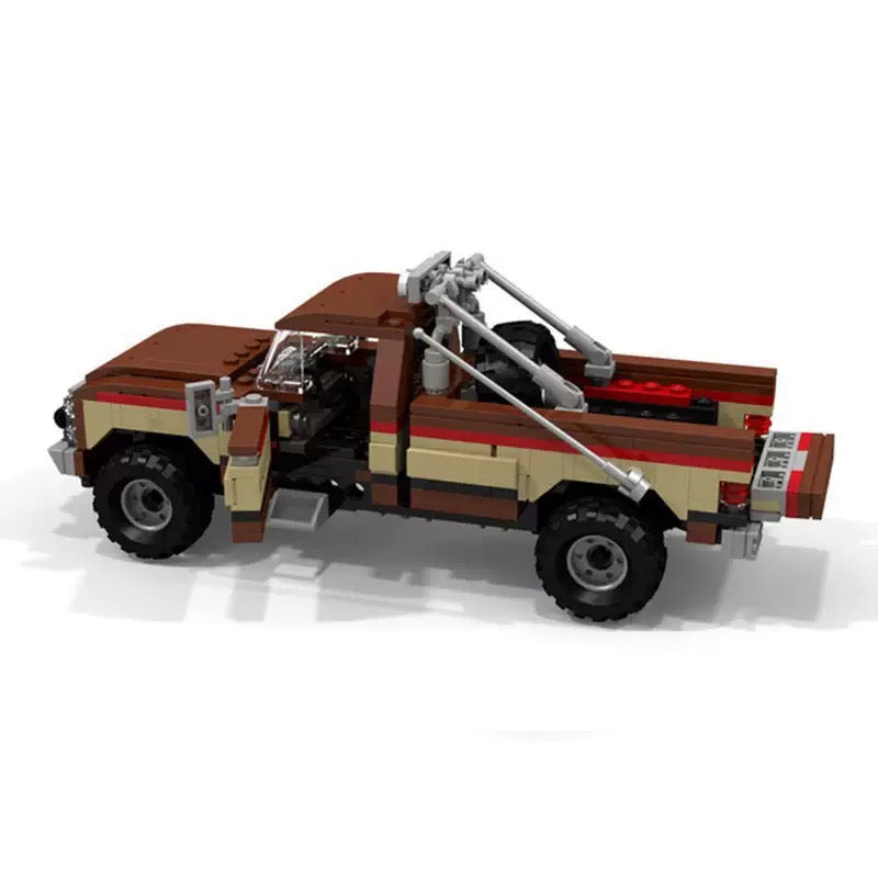 RevvBlox Fall Guy Pickup Truck toy model with detailed orange and black design, featuring rugged truck features and realistic details.