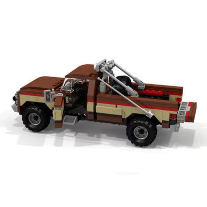 RevvBlox Fall Guy Pickup Truck toy model with detailed orange and black design, featuring rugged truck features and realistic details.