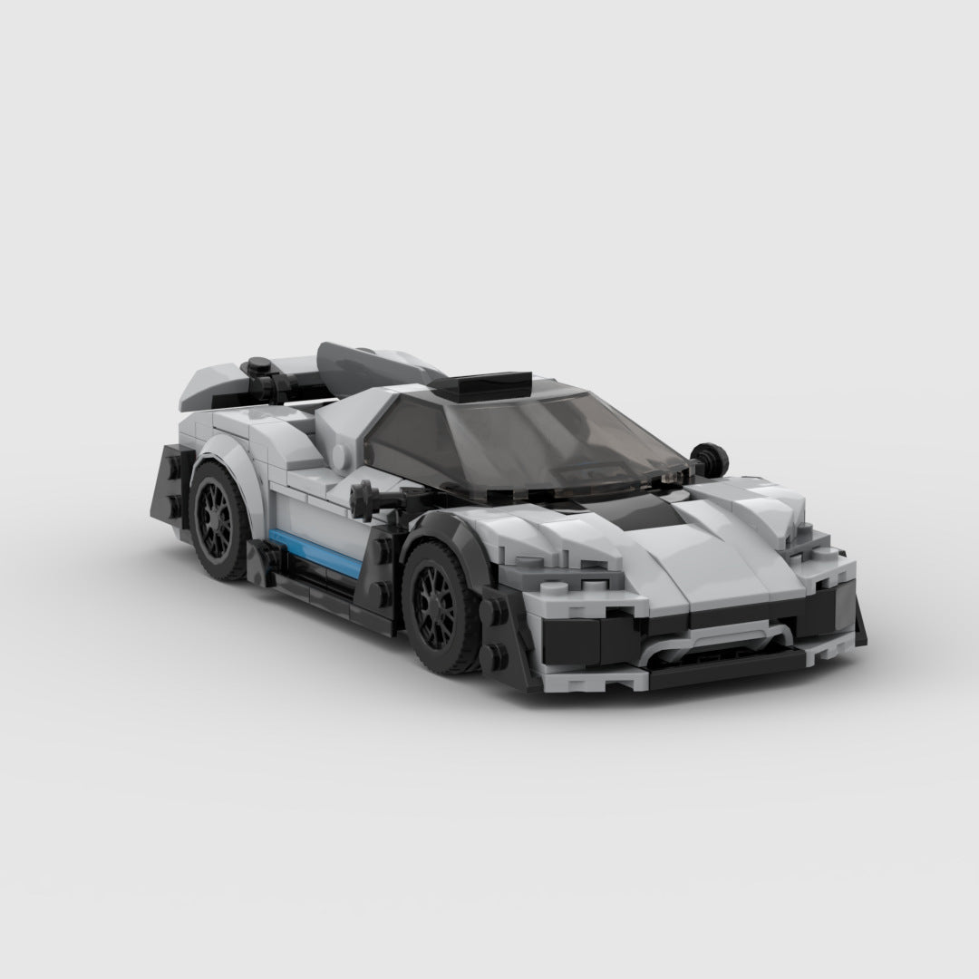 White and black LEGO model of a Mercedes AMG One hypercar with blue side detail