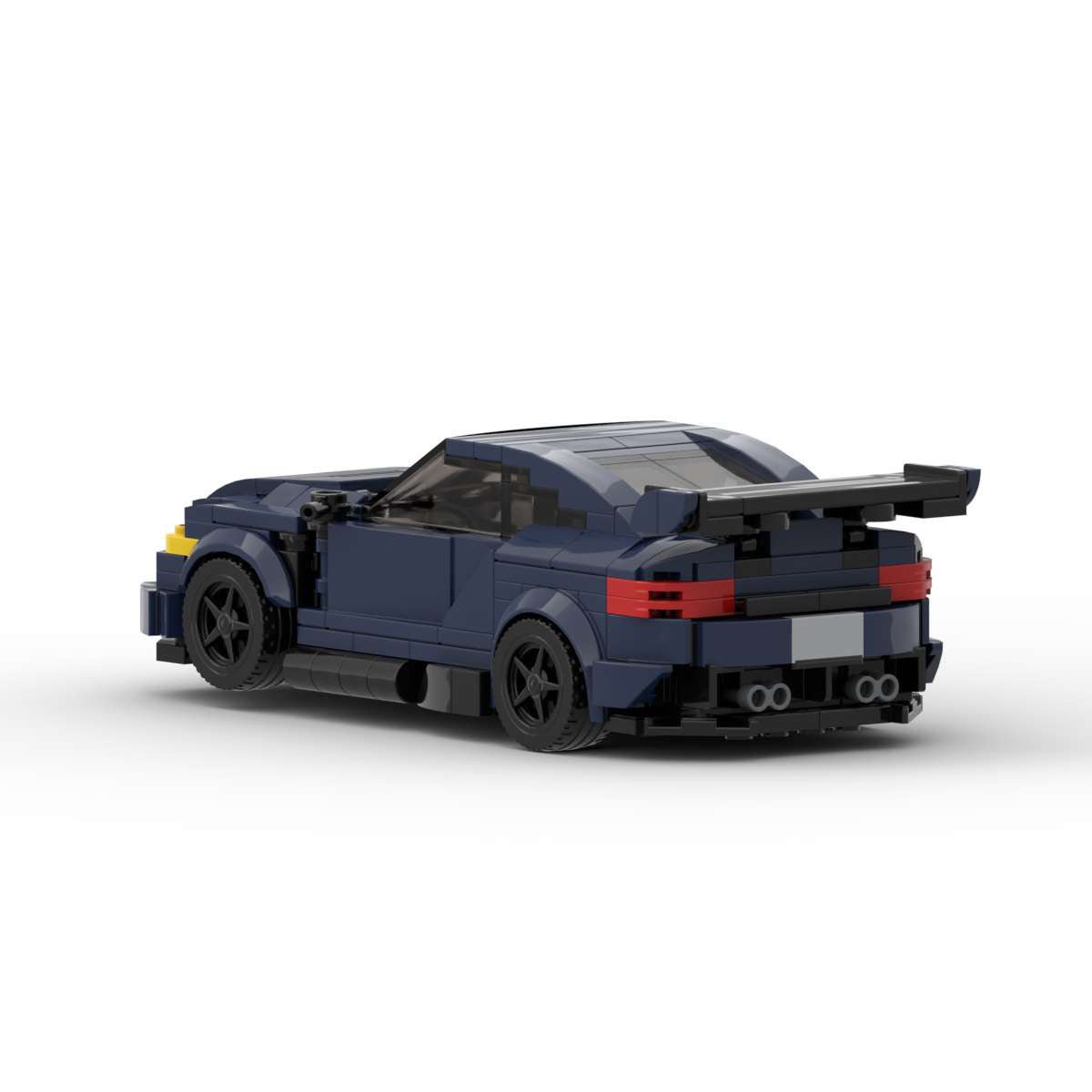 Rear-side view of a dark blue LEGO sports car model with wide spoiler and black wheels on white background