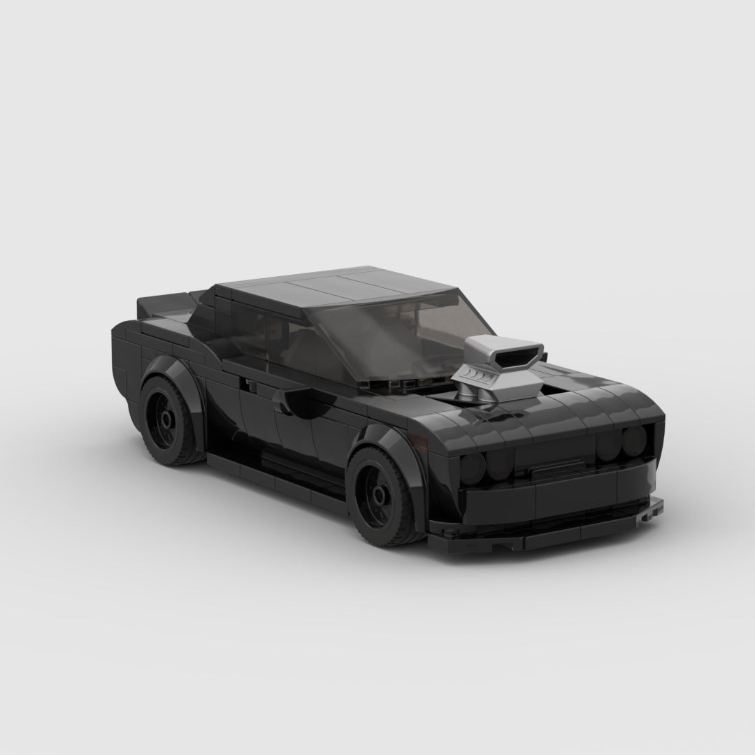 Black LEGO muscle car model with hood scoop and detailed body on white background