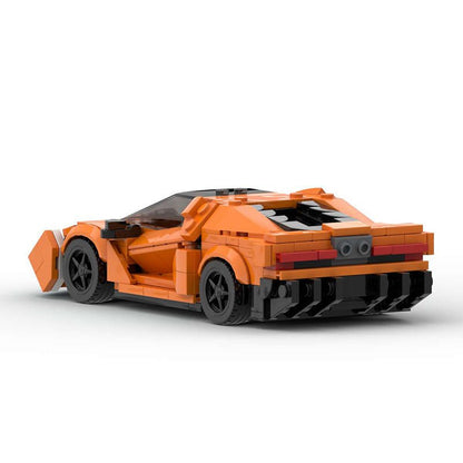 Rear view of orange LEGO sports car model with black wheels on white background