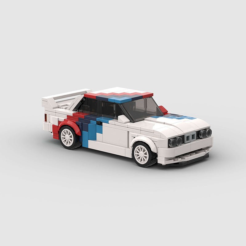 Lego model of a white race car with red and blue accents and a rear spoiler on a grey background
