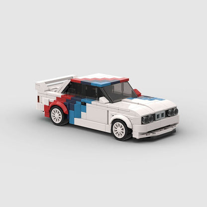 Lego model of a white race car with red and blue accents and a rear spoiler on a grey background