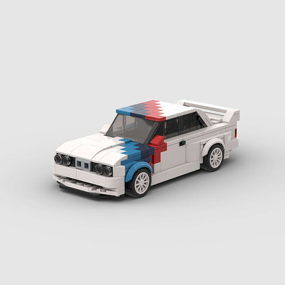 LEGO model of a vintage race car with white, blue, and red color blocks on hood and roof, featuring rear spoiler
