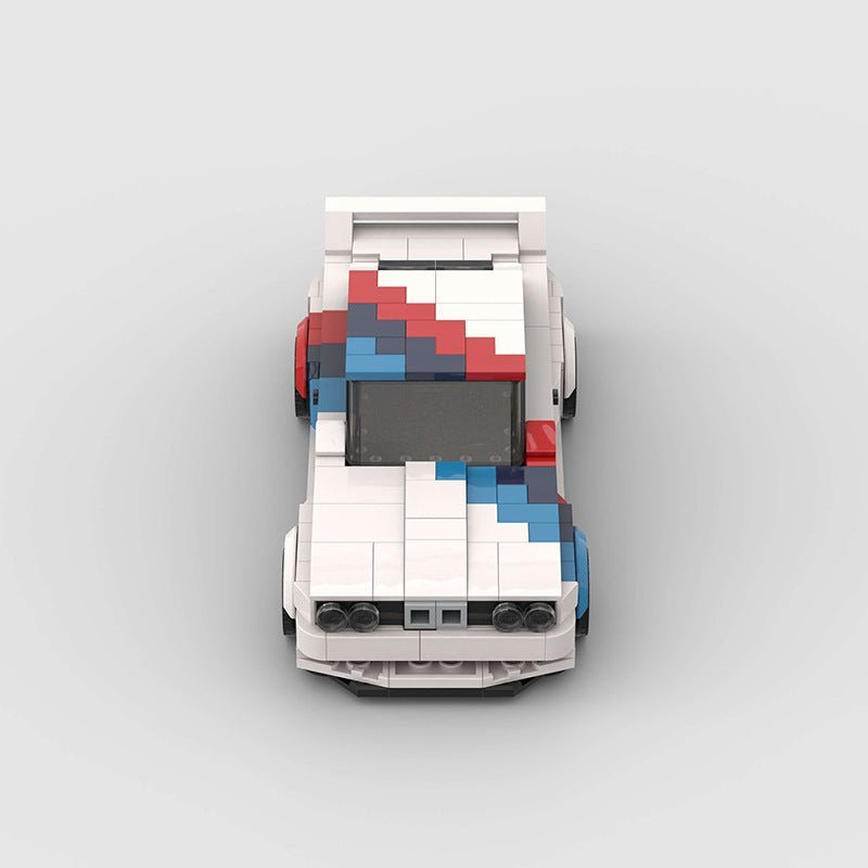 Top view of a white LEGO race car with red and blue racing stripes on a gray background