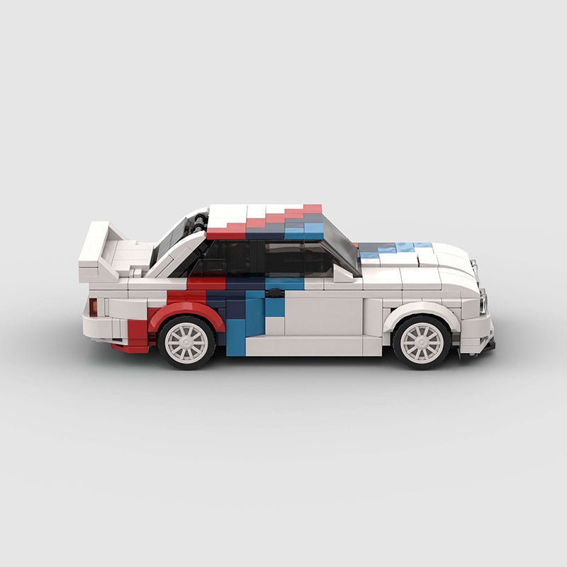 White LEGO model of a classic BMW M3 E30 with red and blue racing stripe details