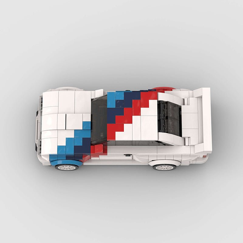 Top view of a white Lego race car model with blue and red racing stripes on a gray background