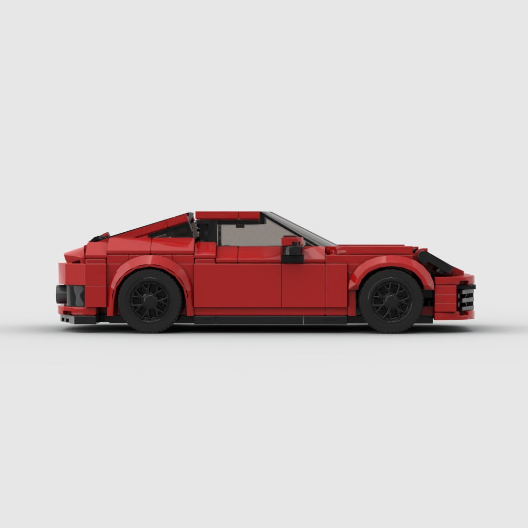 Red LEGO model of a sports car resembling a Porsche 911 with black wheels on a white background