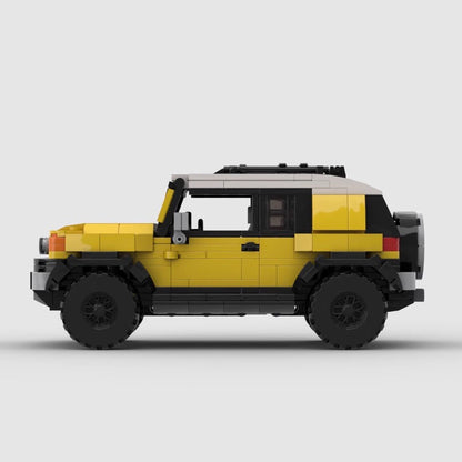Yellow and white LEGO model of a Toyota FJ Cruiser SUV on a plain gray background