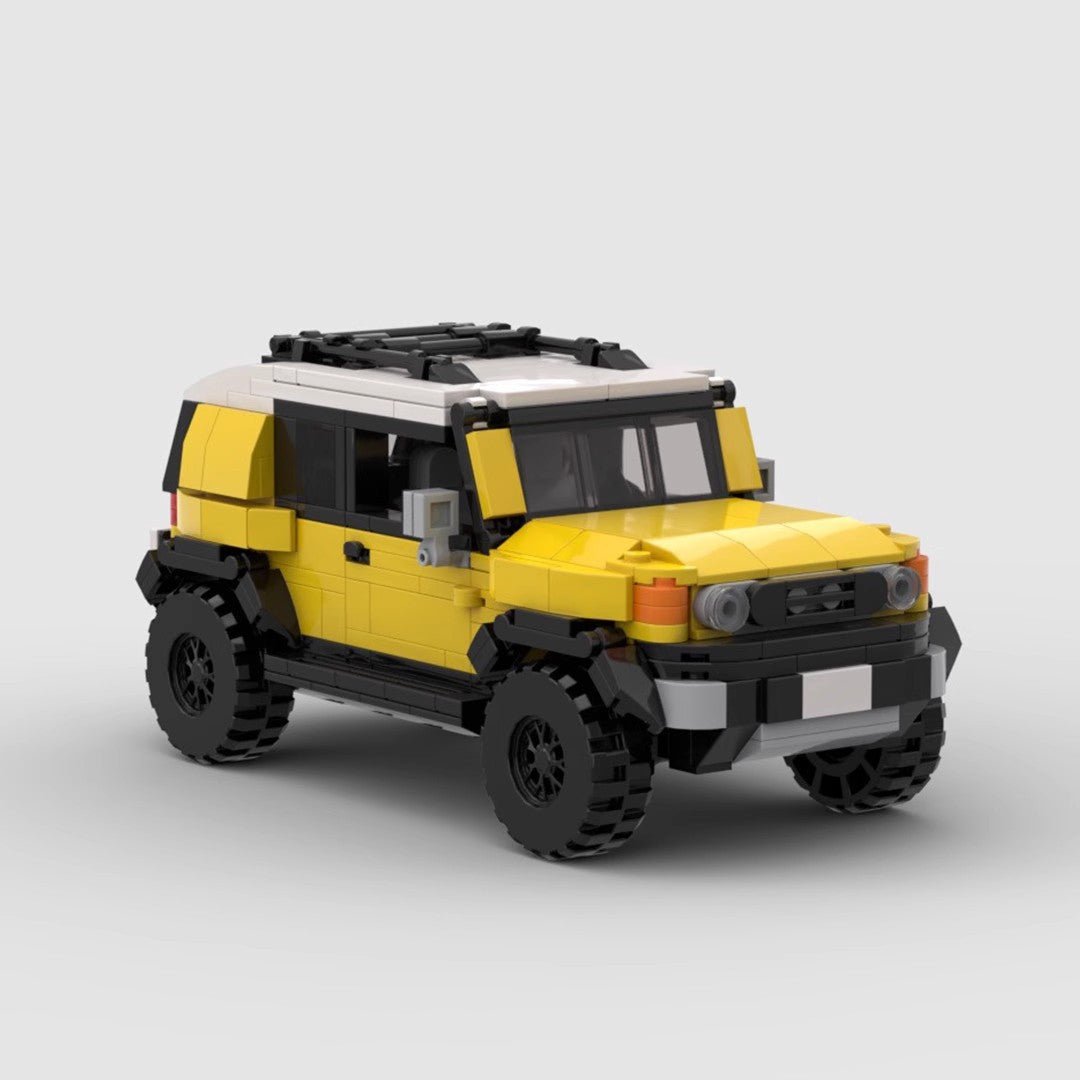 Yellow and white LEGO model of Toyota FJ Cruiser SUV with black roof rack and off-road tires